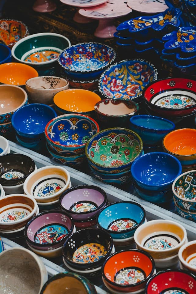 An assortment of colourful, individually decorated ceramic bowls displayed at a market in Tehran, Iran.