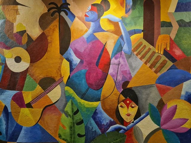 Vivid abstract wall painting with interlocking shapes, faces and bright colours.