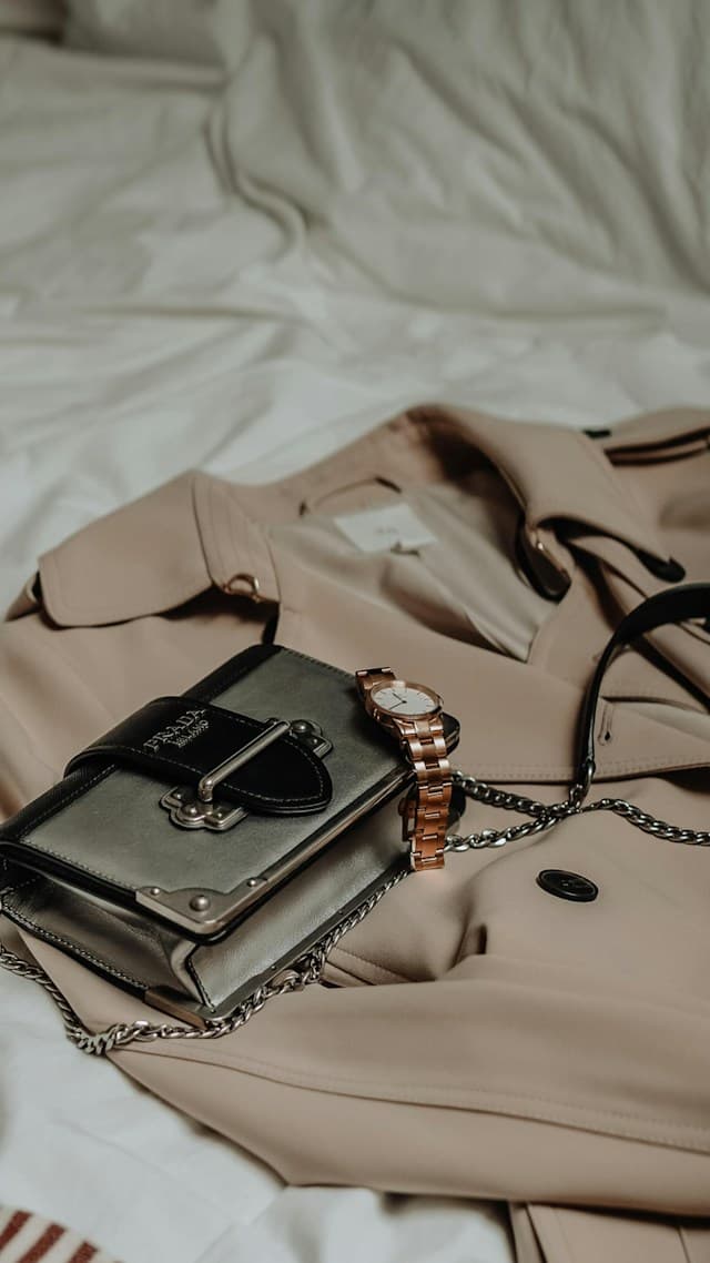 Watch and handbag resting on a trench coat