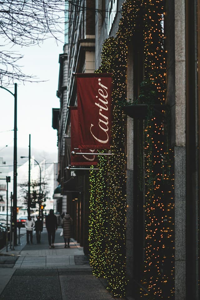 Cartier flags displayed outside a luxury boutique.