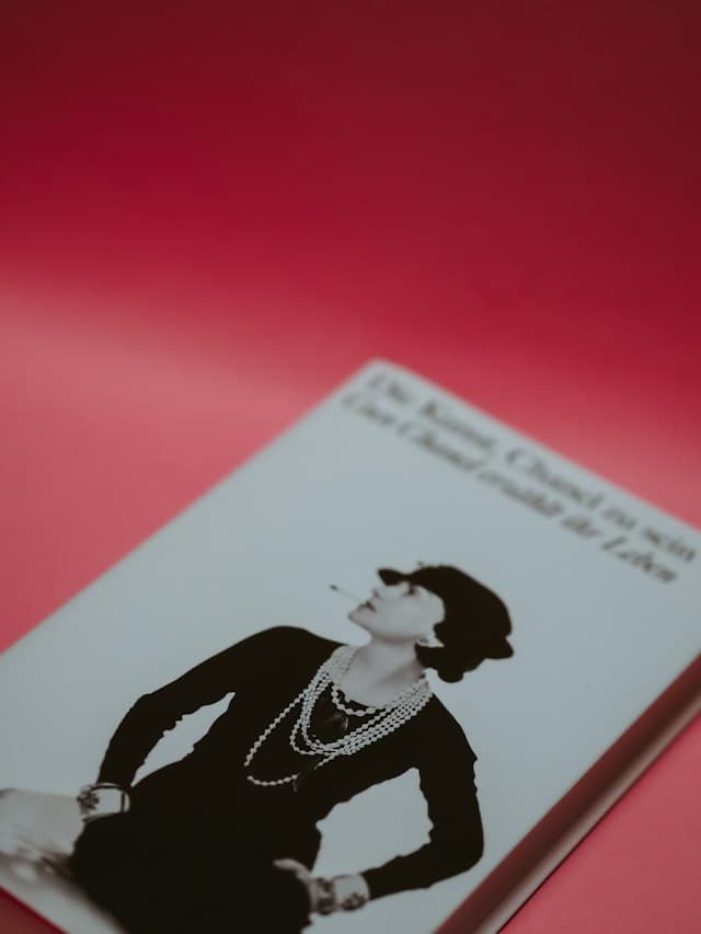 A fashion book displaying a portrait of Coco Chanel.