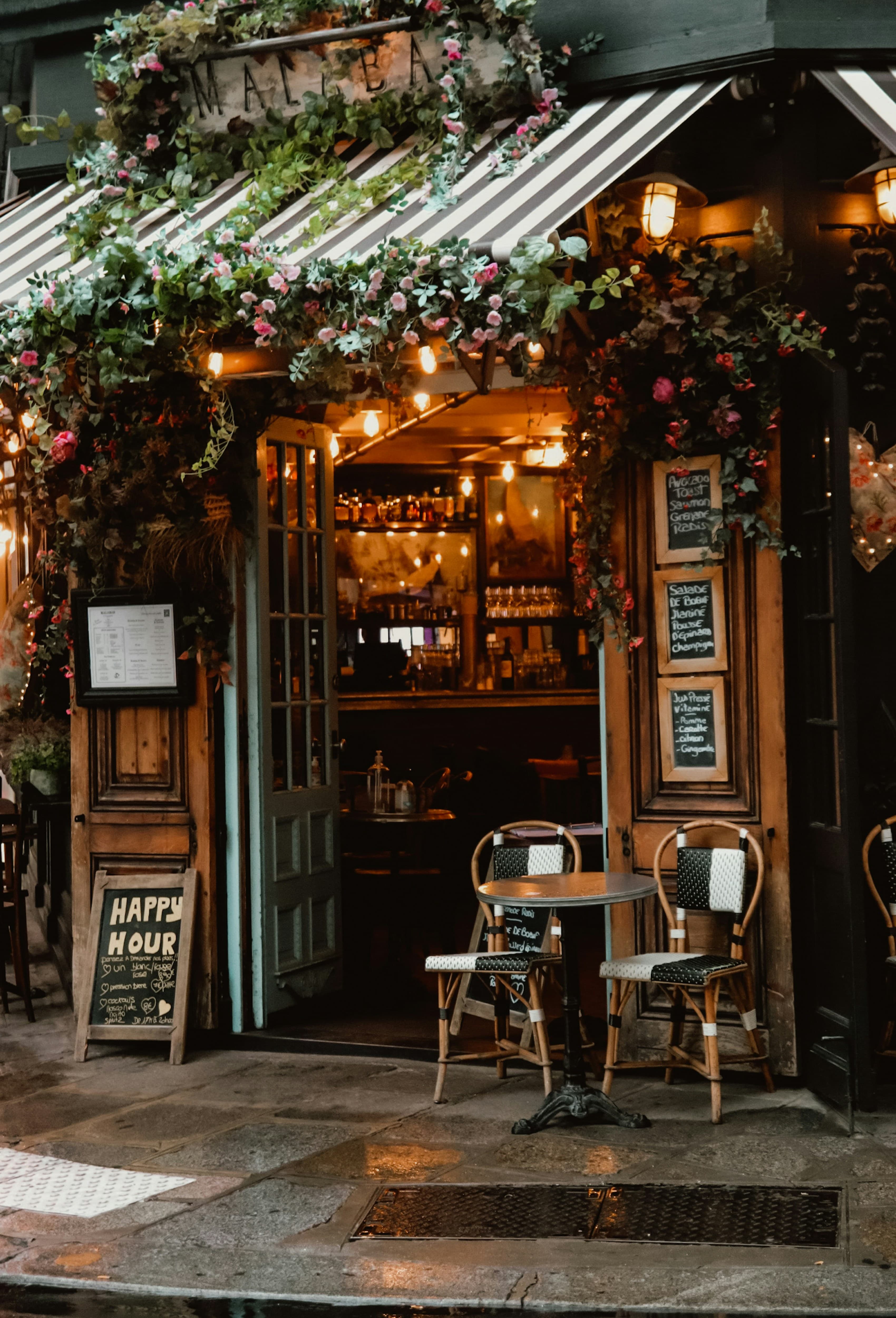 An inviting Paris café with flowers and a wooden entrance